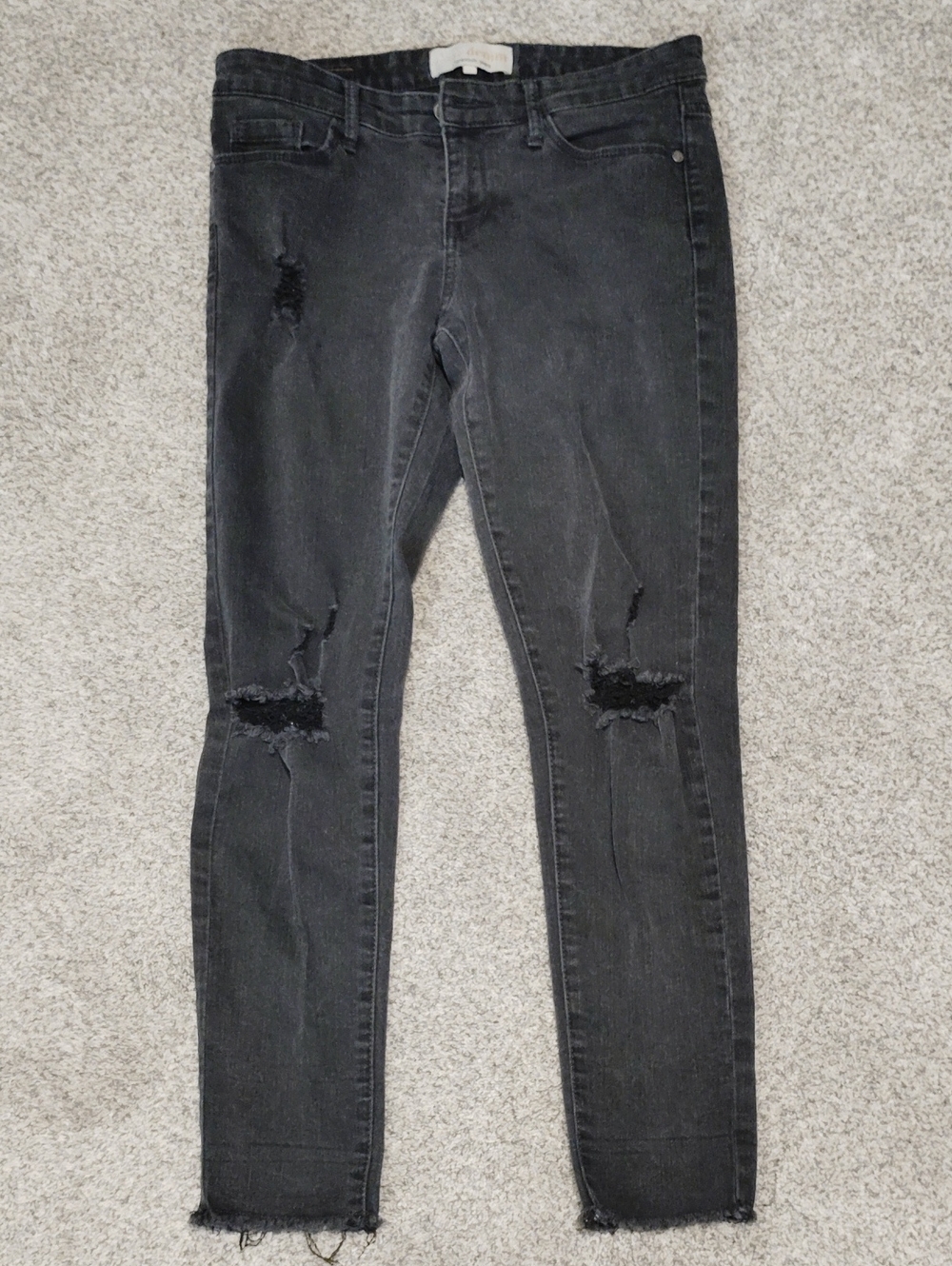 Women’s Distressed Black Skinny Jeans with Raw Hem